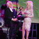 Dolly Parton singing “I Will Always Love You” at Kenny Rogers’s farewell concert on October 25th. Image via the AP.